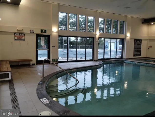 a front view of a house with swimming pool having outdoor seating