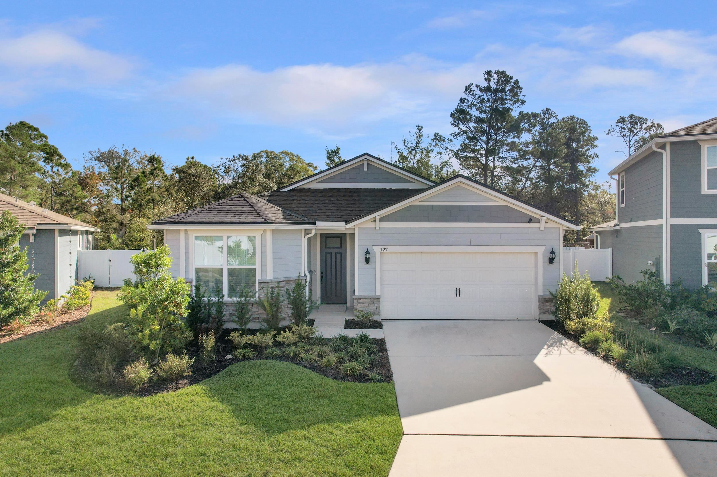 127 Shell Crk Court St. Augustine, FL 32086 - Photo 3 of 37 a front view of a house with a garden