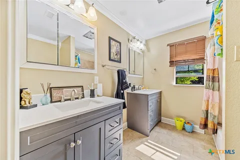 a room with a sink and a mirror