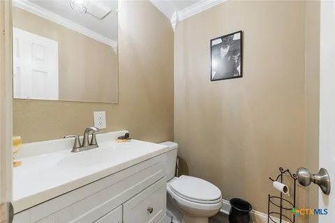 a bathroom with a sink a toilet and mirror