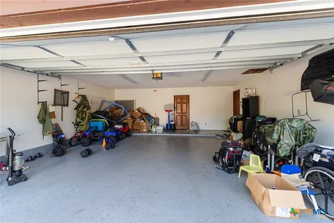 a view of a garage with a bike and wooden floor