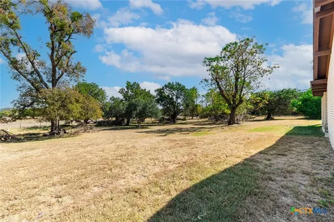 a view of yard with large trees