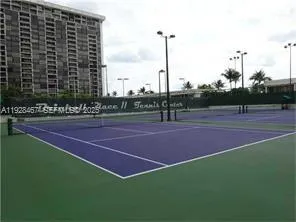 a tennis court with view of city