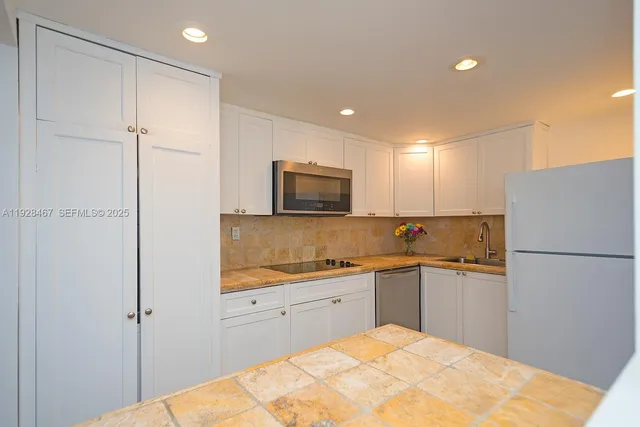a kitchen with a refrigerator and a sink