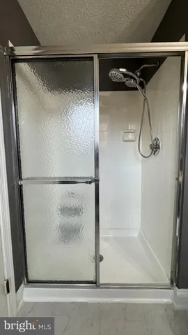 a bathroom with a glass shower door