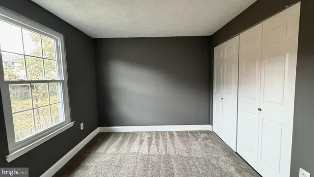 a view of a room with wooden floor and windows
