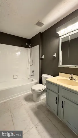 a bathroom with a double vanity sink toilet mirror and bathtub