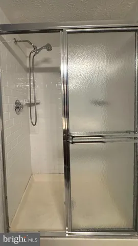 a bathroom with a glass shower door