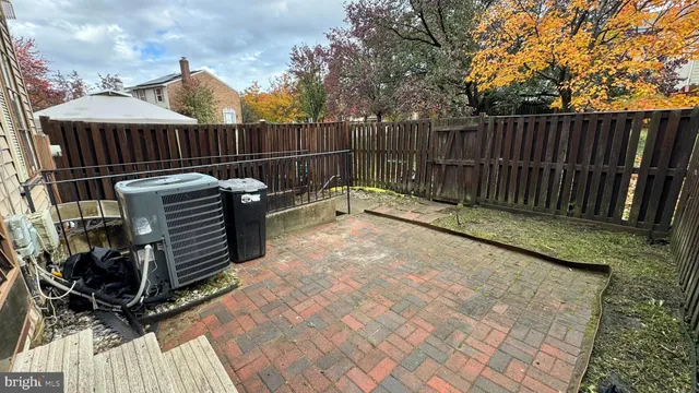 a view of a backyard with wooden fence