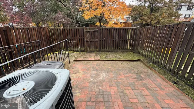 a balcony with wooden floor table and chairs