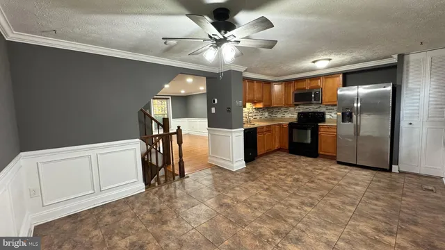 a kitchen with refrigerator and cabinets