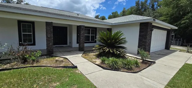 a front view of a house with garden