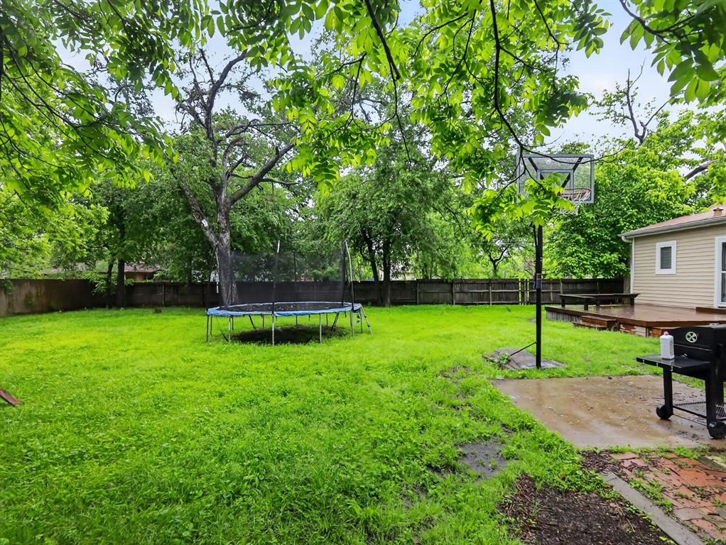 1301 Locust Street Commerce, TX 75428 - Photo 14 of 17 a view of a backyard with a slide