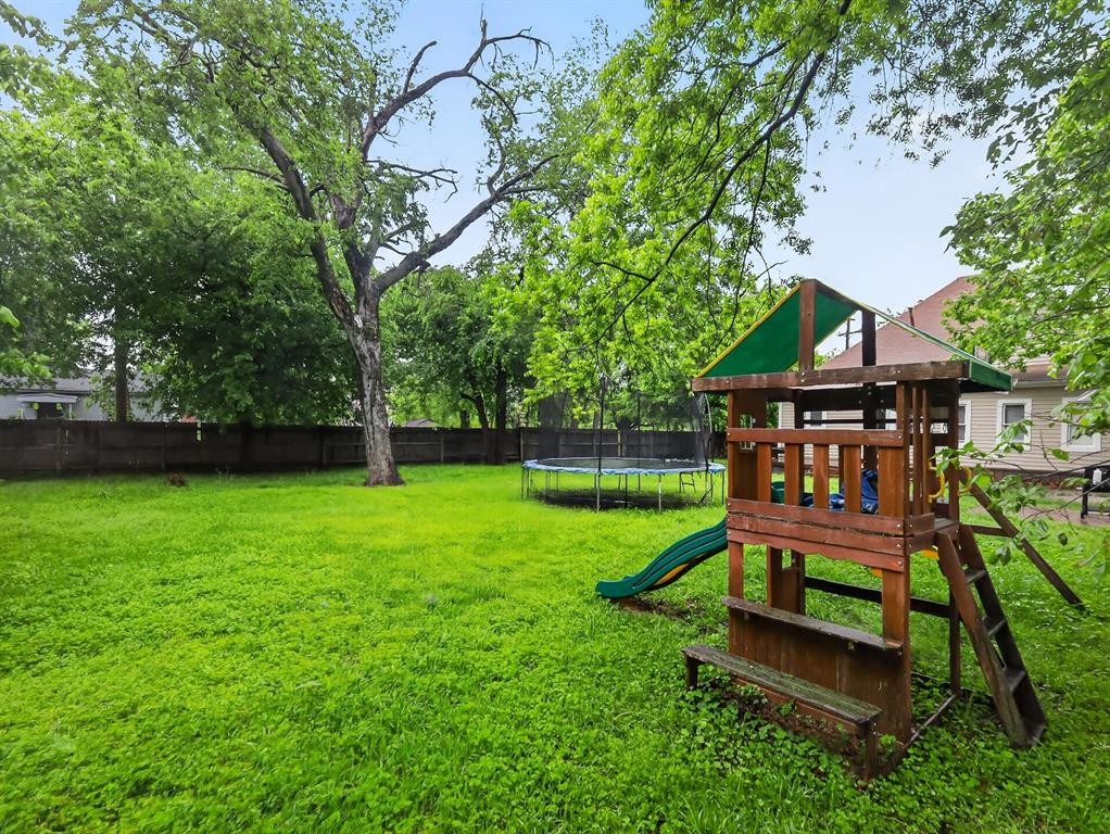 1301 Locust Street Commerce, TX 75428 - Photo 17 of 17 a view of a wooden deck with a bench and a small yard