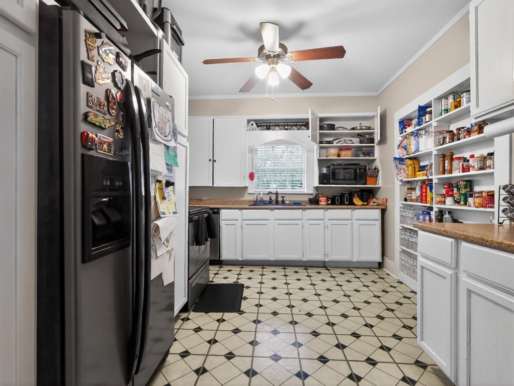 1301 Locust Street Commerce, TX 75428 - Photo 2 of 17 a kitchen with stainless steel appliances a refrigerator and a stove top oven