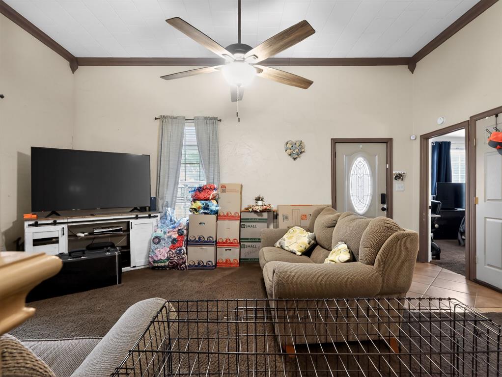 1301 Locust Street Commerce, TX 75428 - Photo 5 of 17 a living room with furniture and a flat screen tv