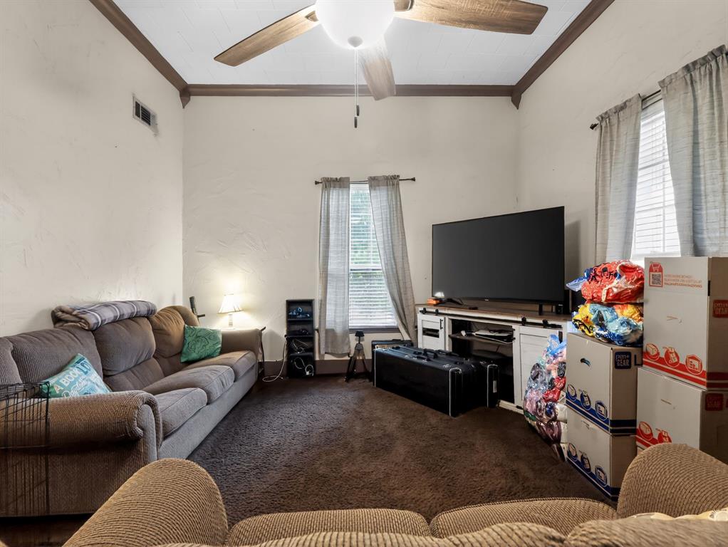 1301 Locust Street Commerce, TX 75428 - Photo 6 of 17 a living room with furniture and a flat screen tv