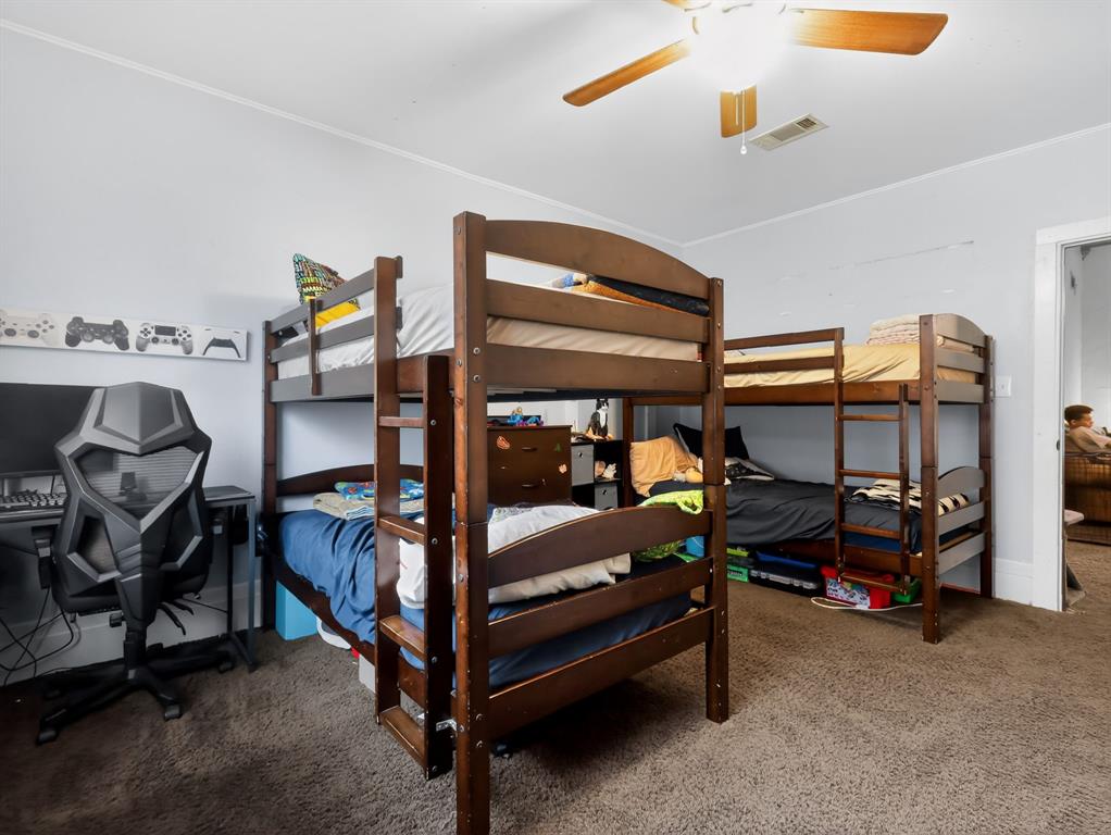 1301 Locust Street Commerce, TX 75428 - Photo 8 of 17 a bedroom with double bunk beds and painted walls