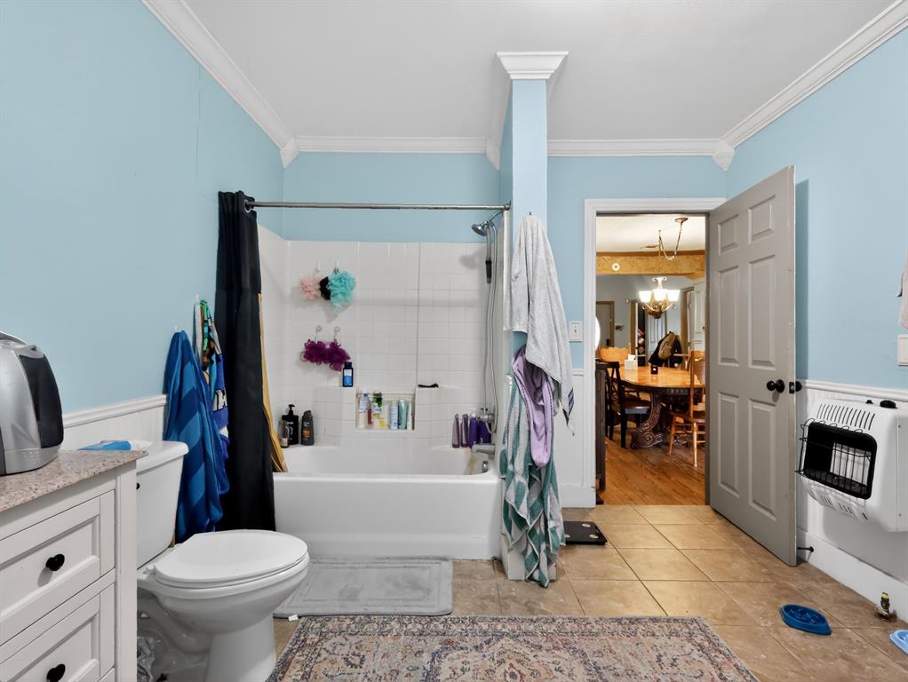 1301 Locust Street Commerce, TX 75428 - Photo 9 of 17 a bathroom with a sink toilet mirror and shower