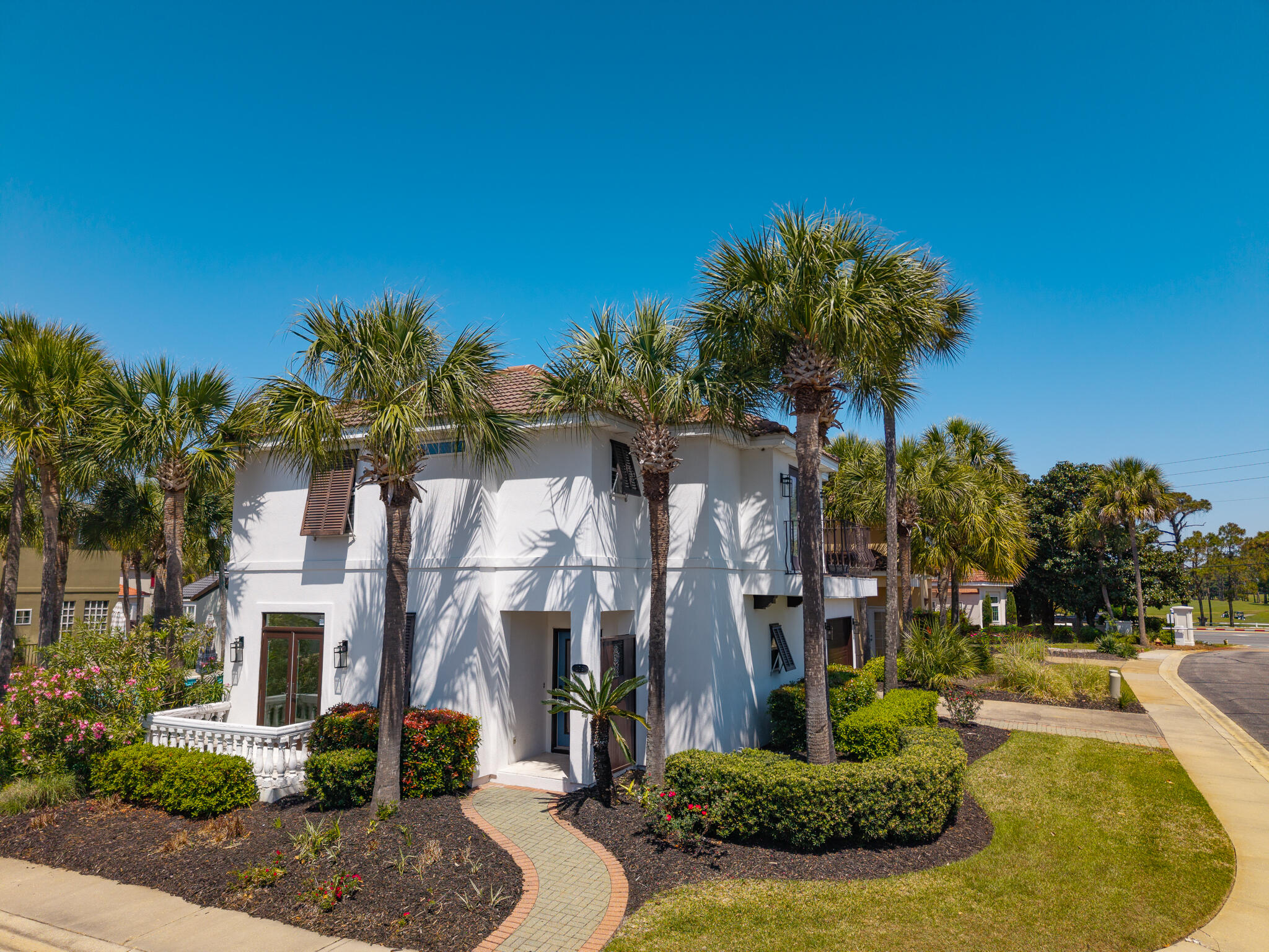a front view of a house with a yard and tree s