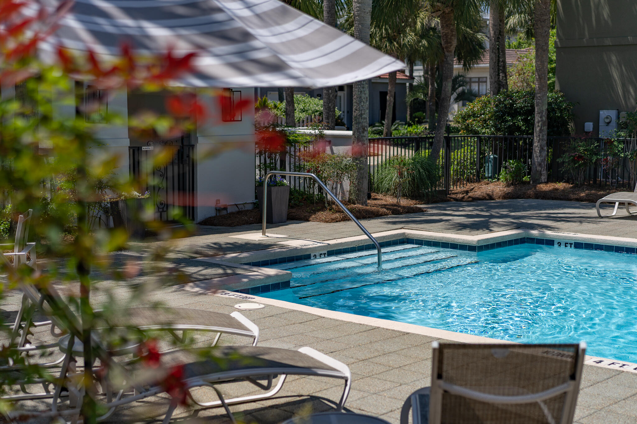 106 Tuscany Drive Destin, FL 32541 - Photo 19 of 41 a view of a patio with table and chairs potted plants and large tree