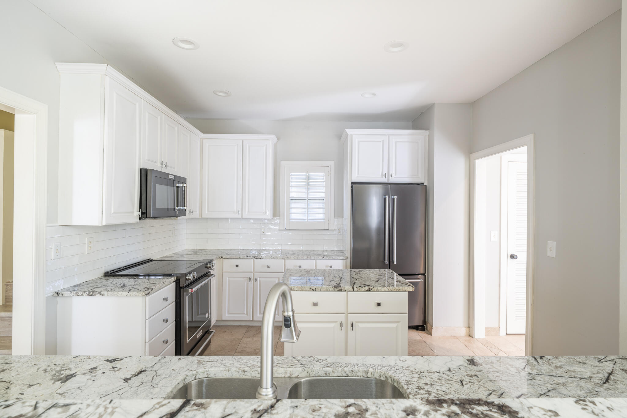 106 Tuscany Drive Destin, FL 32541 - Photo 8 of 41 a kitchen with stainless steel appliances granite countertop a stove a sink and a refrigerator