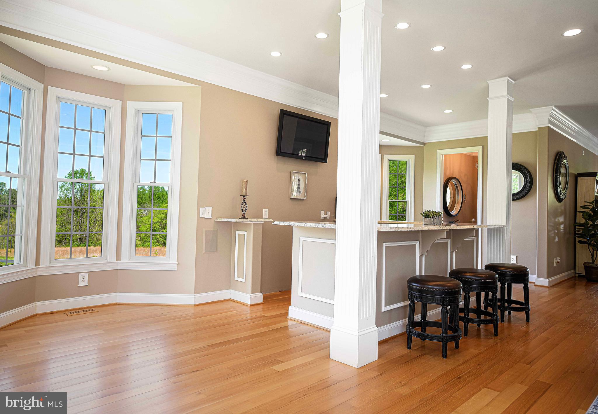 2874 Ady Road Forest Hill, MD 21050 - Photo 31 of 85 a open kitchen with granite countertop a refrigerator a stove a dining table and chairs with wooden floor