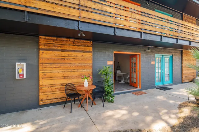 a view of a porch with a table and chairs and potted plants