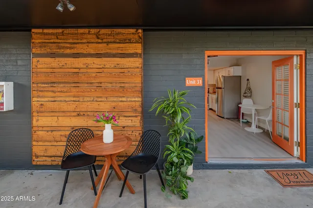 a backyard of a house with outdoor seating