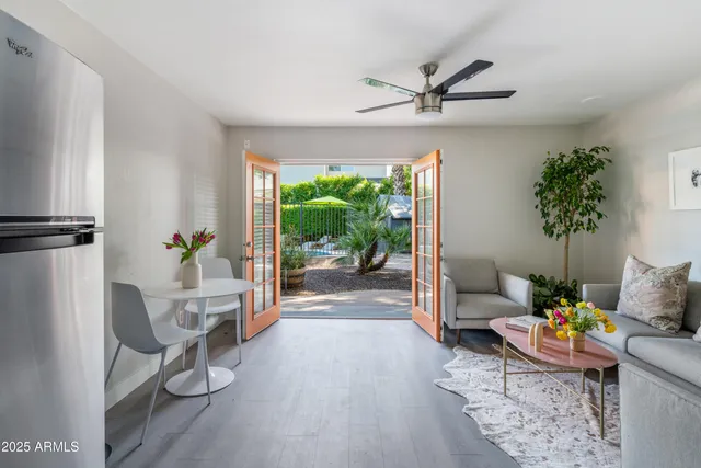 a living room with furniture and a floor to ceiling window