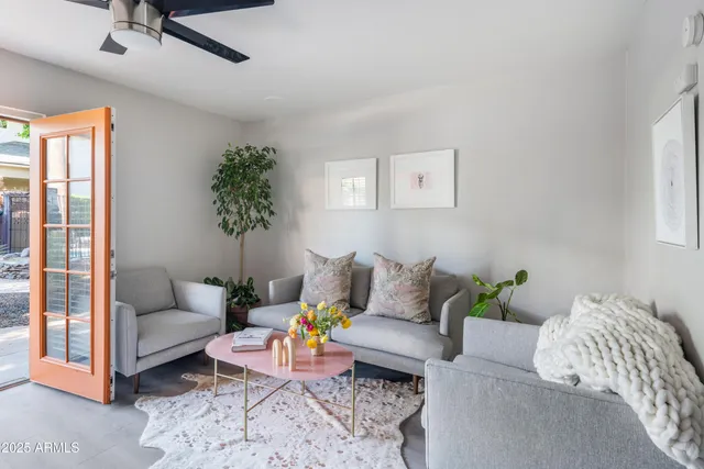a living room with furniture and a potted plant