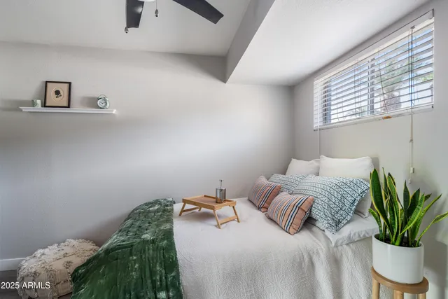 a bedroom with bed and a window