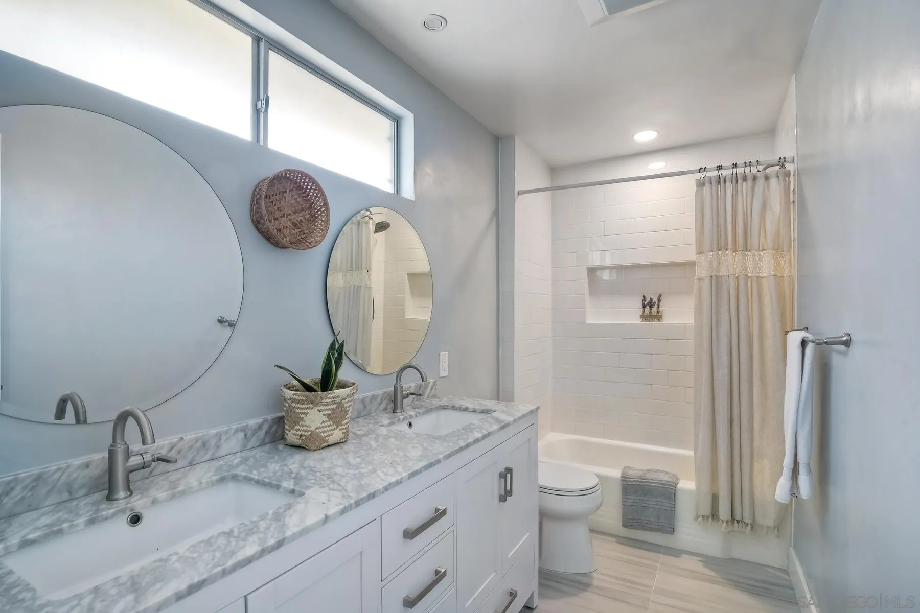 1451 Ridge Road Vista, CA 92081 - Photo 19 of 31 a bathroom with a granite countertop sink a toilet and a mirror