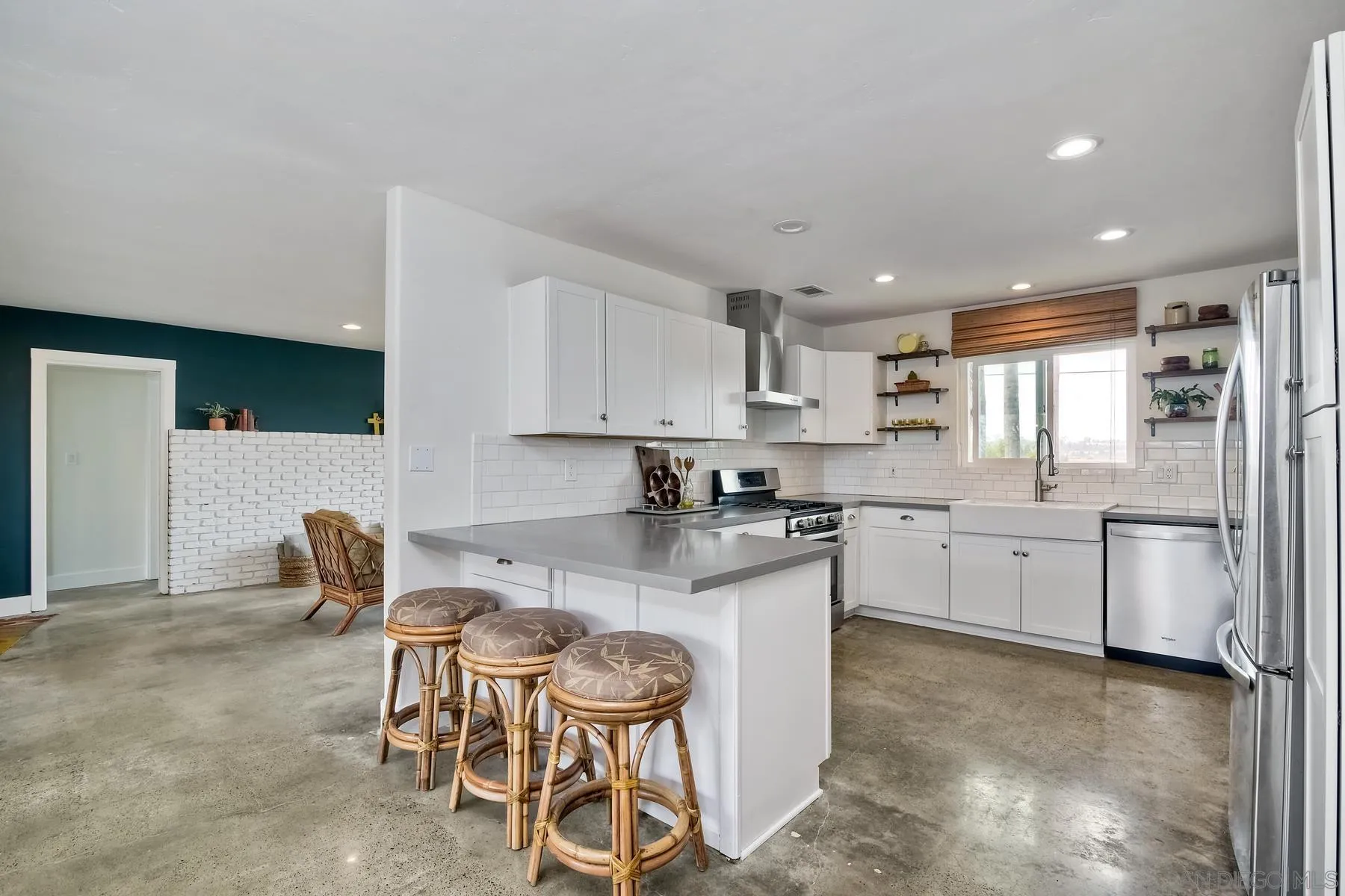 1451 Ridge Road Vista, CA 92081 - Photo 5 of 31 a kitchen with granite countertop cabinets a stove a dining table and chairs