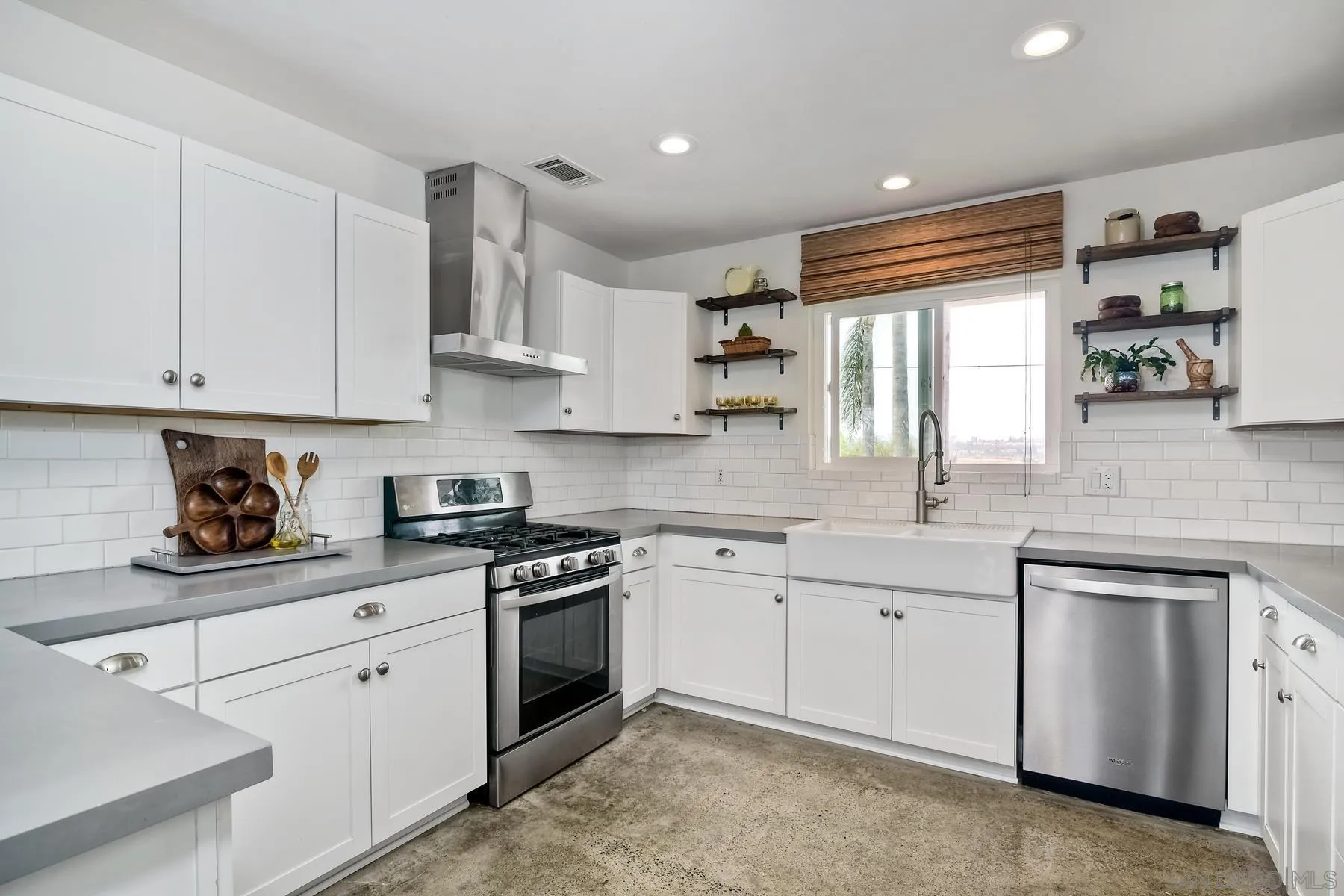 1451 Ridge Road Vista, CA 92081 - Photo 6 of 31 a kitchen with white cabinets stainless steel appliances and sink