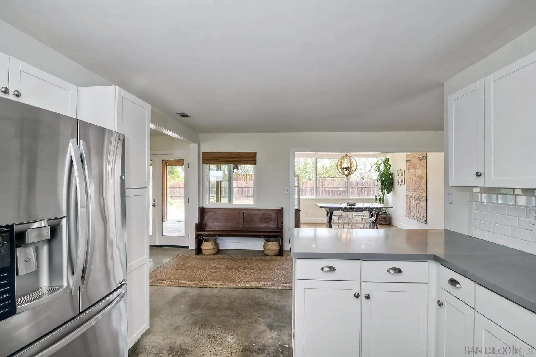 1451 Ridge Road Vista, CA 92081 - Photo 8 of 31 a kitchen with granite countertop a refrigerator and a sink