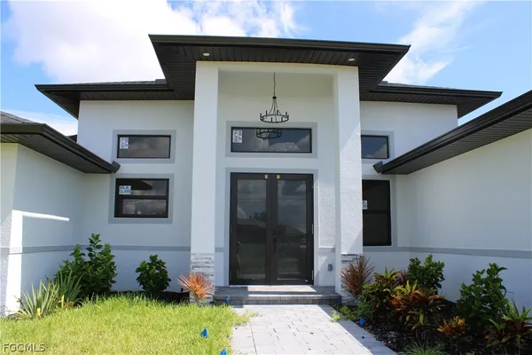 a front view of a house with garden