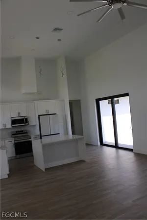 a view of kitchen with furniture and wooden floor