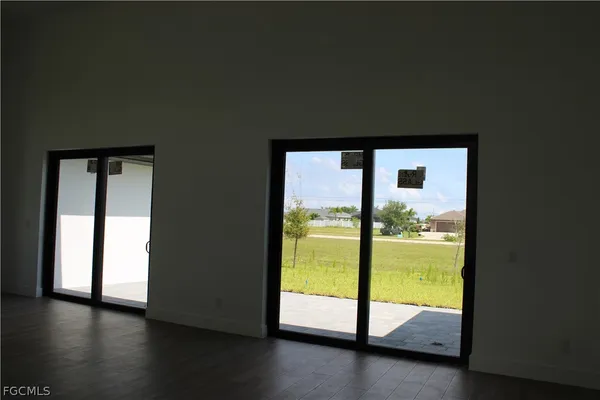 a view of an empty room and wooden floor