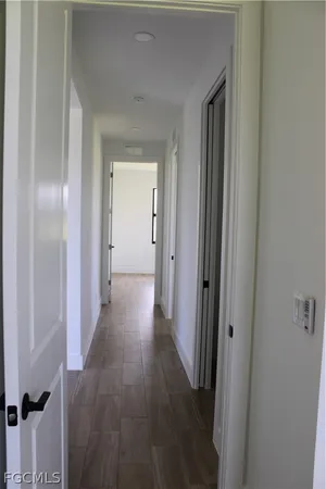 a view of a hallway with wooden floor