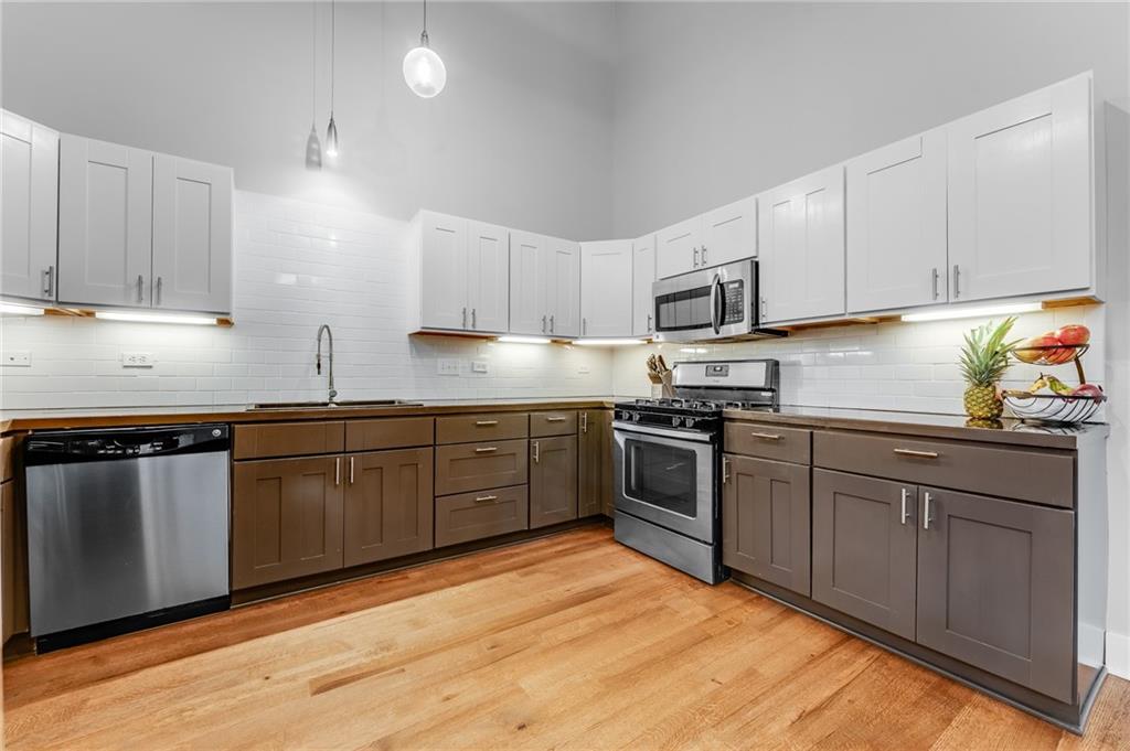 10 Walnut Street, Unit 7 Pittsburgh, PA 15202 - Photo 3 of 49 a kitchen with granite countertop a stove top oven sink and cabinets