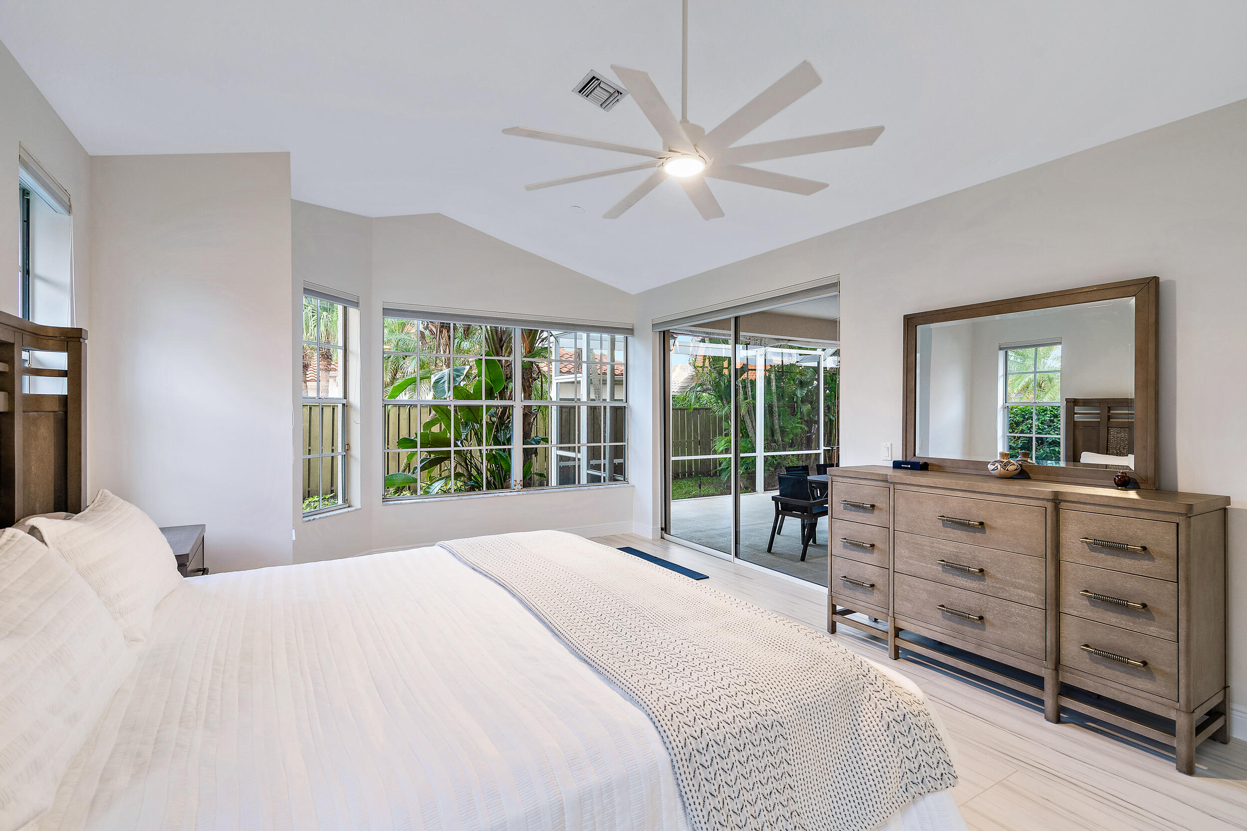 207 Eagleton Estates Boulevard Palm Beach Gardens, FL 33418 - Photo 6 of 34 a bedroom with a large bed and a large window