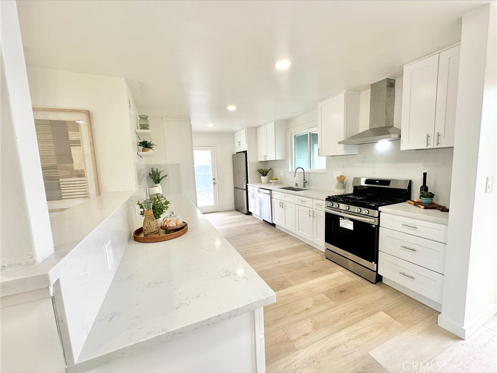 1608 Alviso Street Simi Valley, CA 93065 - Photo 13 of 13 a kitchen with stainless steel appliances granite countertop a sink stove and cabinets