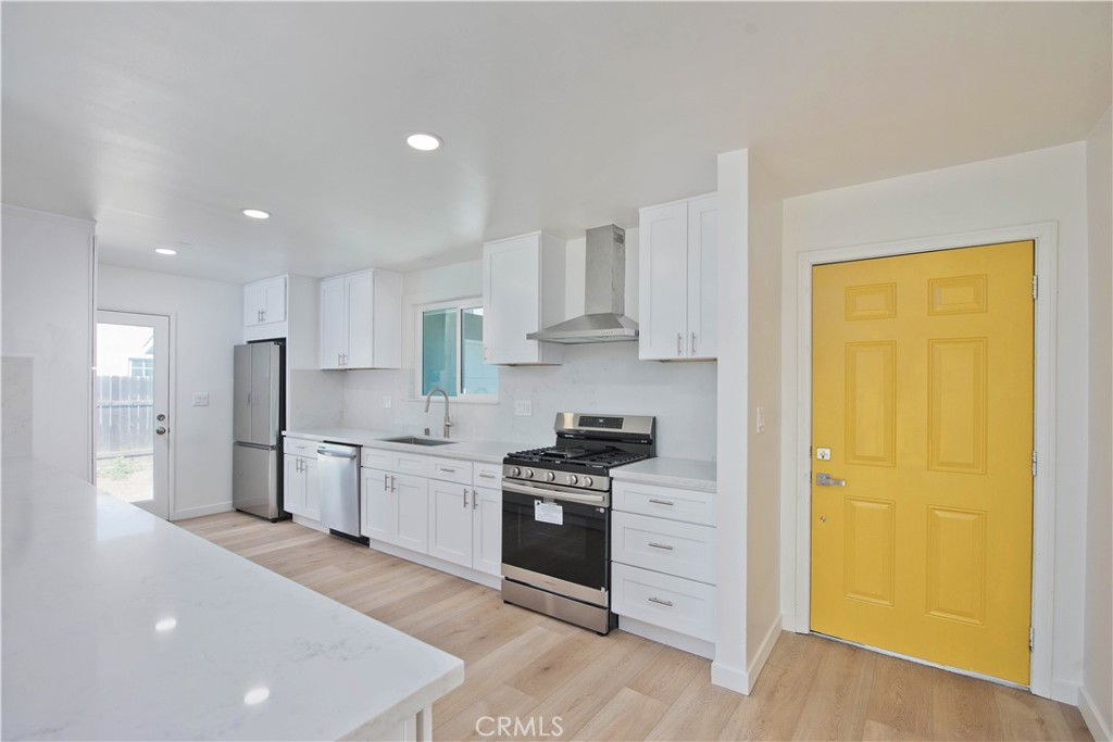1608 Alviso Street Simi Valley, CA 93065 - Photo 4 of 13 a kitchen with stainless steel appliances a stove a sink and a refrigerator