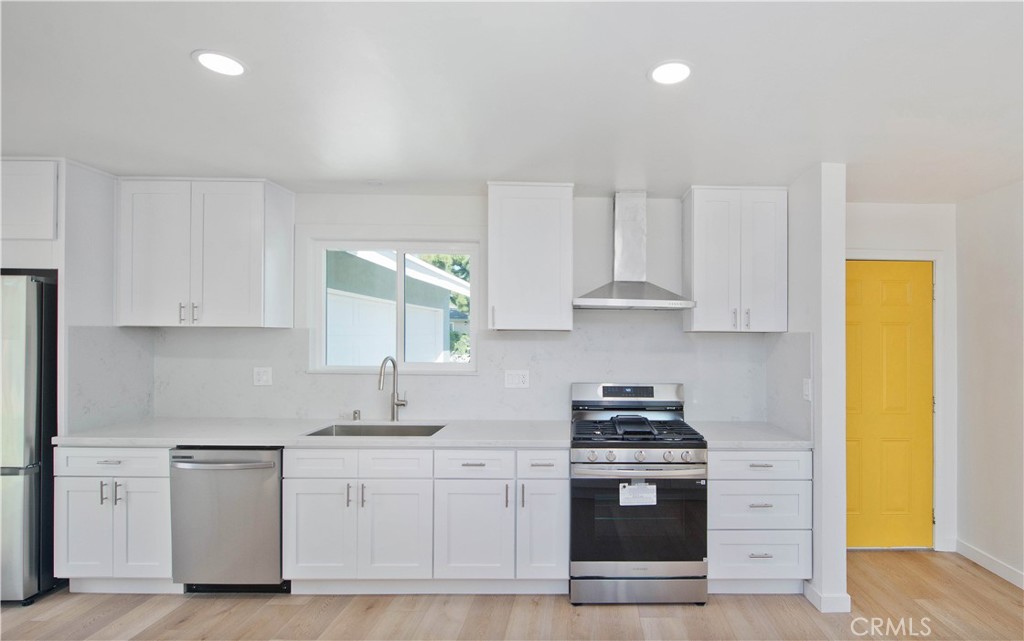 1608 Alviso Street Simi Valley, CA 93065 - Photo 7 of 13 a kitchen with granite countertop white cabinets and stainless steel appliances