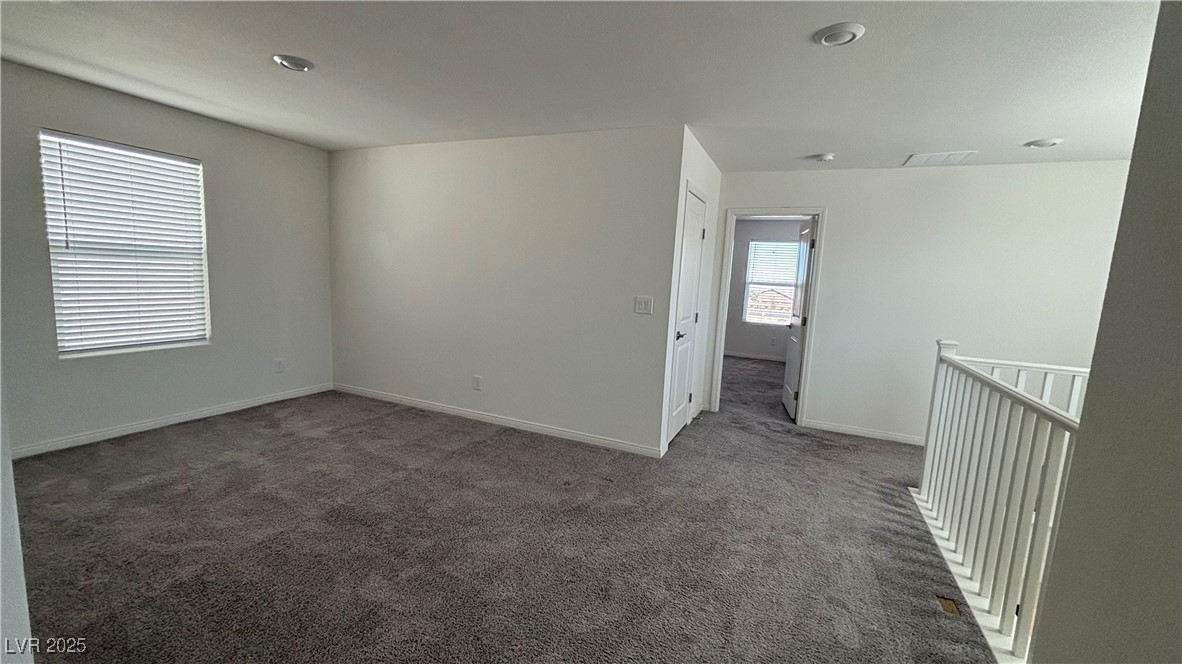 8736 Victoria Pk Street Las Vegas, NV 89148 - Photo 19 of 35 Empty room with dark carpet and baseboards
