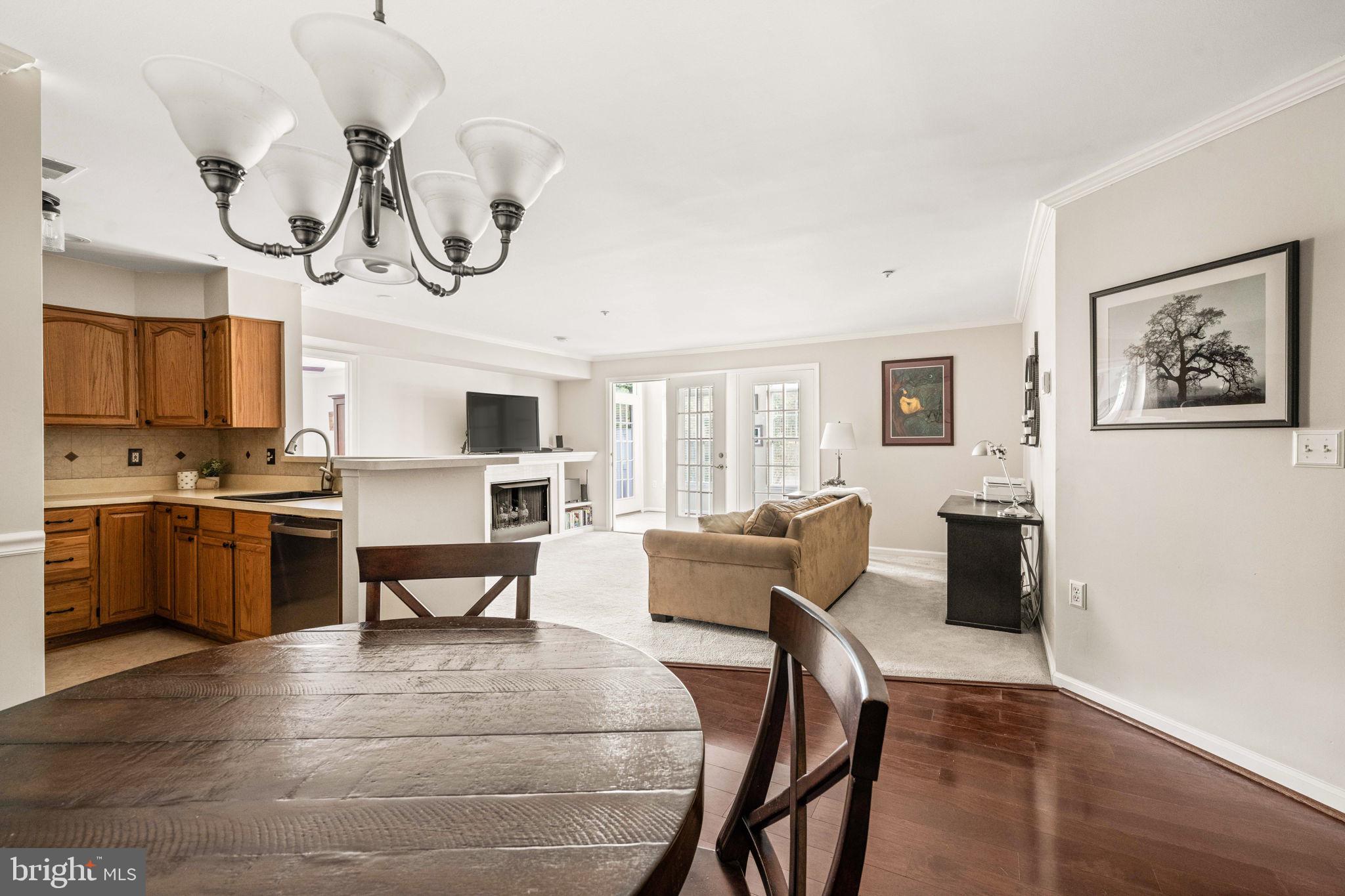 6602 Thackwell Way, Unit C Alexandria, VA 22315 - Photo 11 of 54 a view of dining room and livingroom with furniture wooden floor window and a chandelier