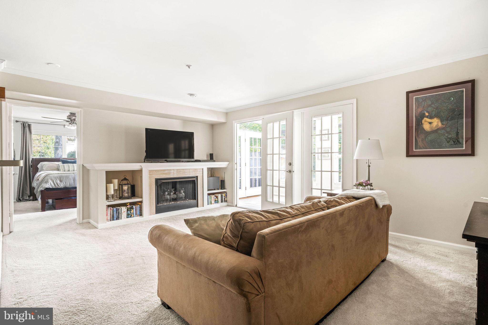 6602 Thackwell Way, Unit C Alexandria, VA 22315 - Photo 12 of 54 a living room with furniture a fireplace and a flat screen tv