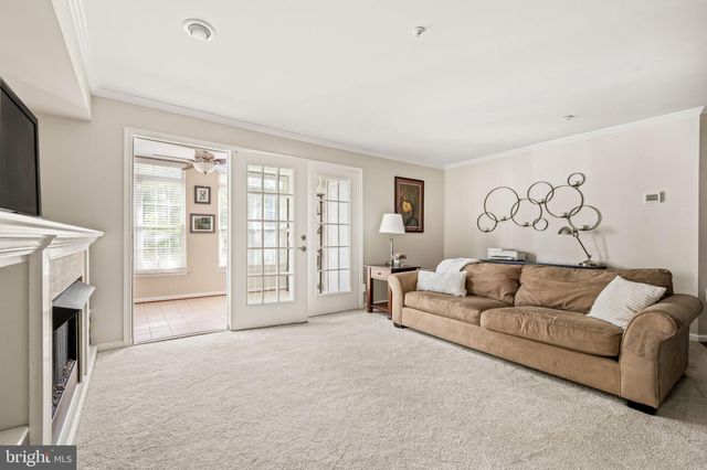 a living room with furniture a fireplace and a large window