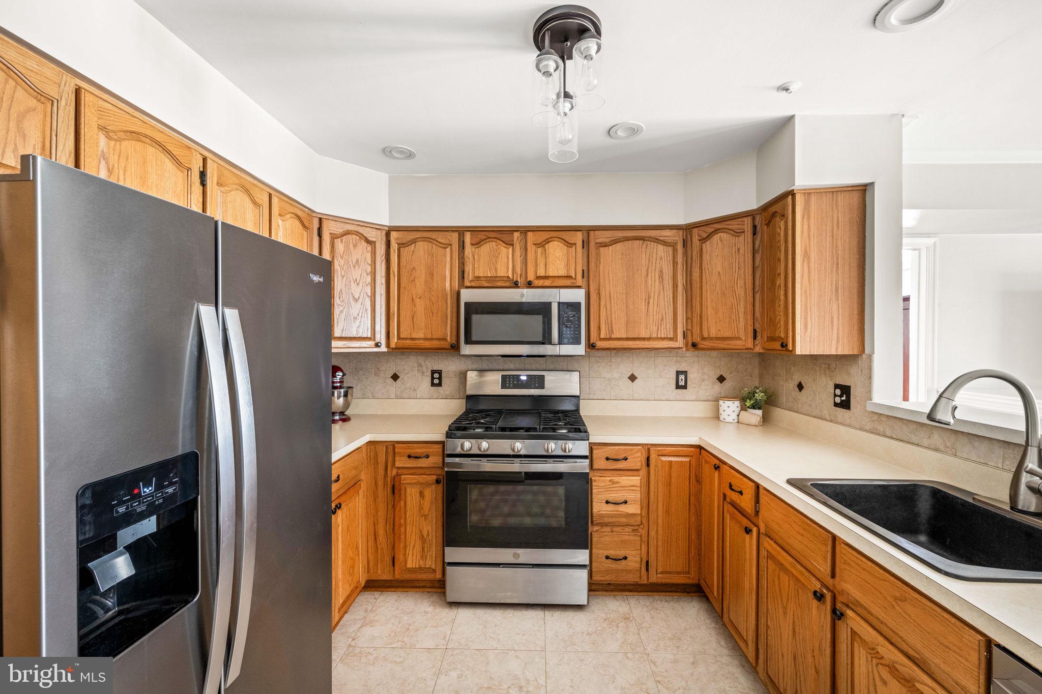 6602 Thackwell Way, Unit C Alexandria, VA 22315 - Photo 17 of 54 a kitchen with a refrigerator sink and stove